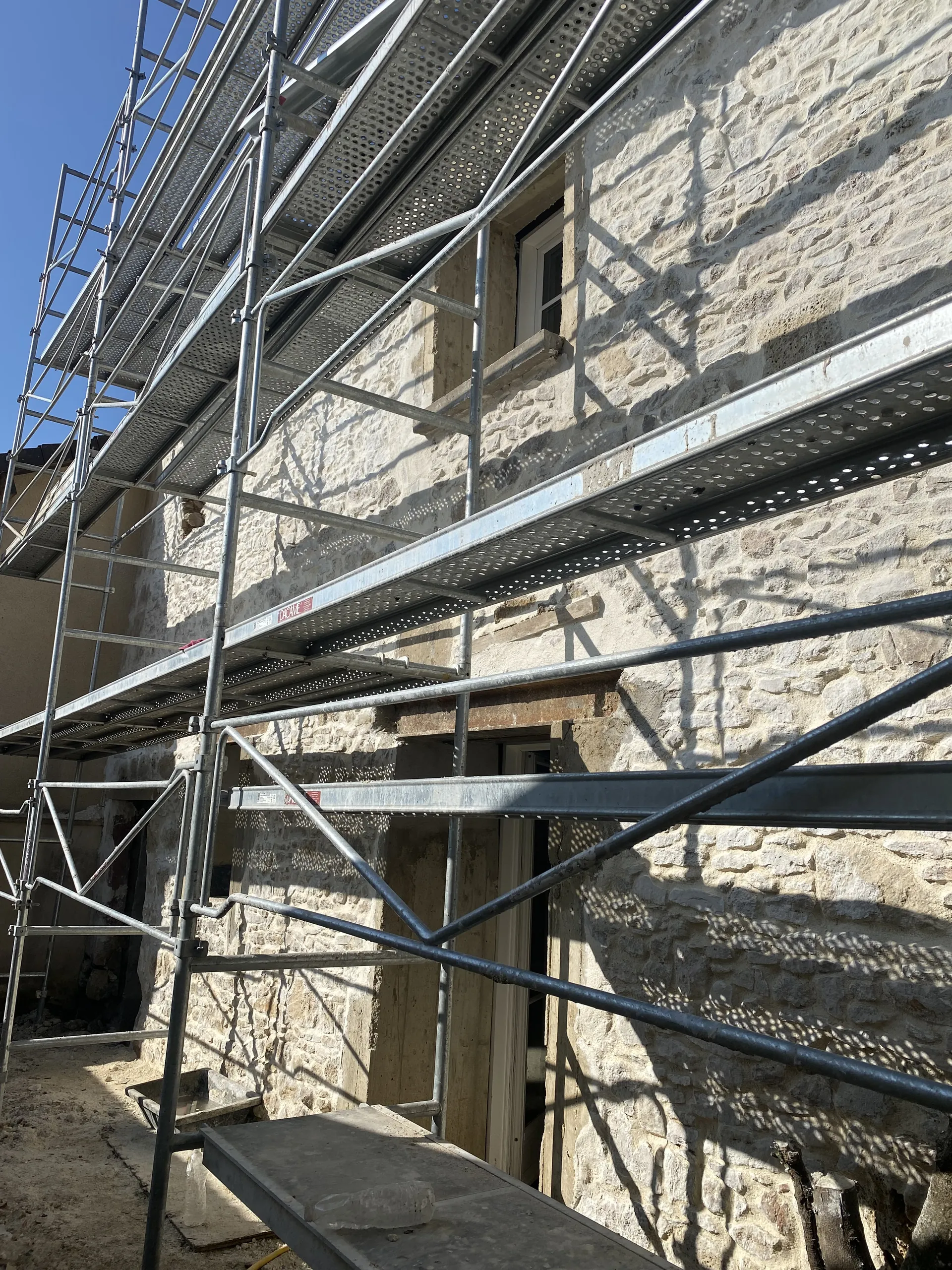 Reprise de la façade en pierre de la Maison de Rully sous échafaudage